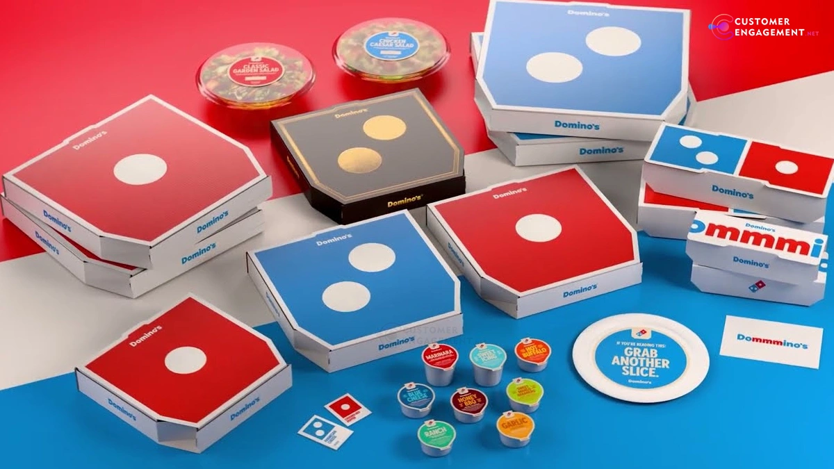 Domino’s new vibrant packaging and logo showcasing its 2025 brand refresh with brighter reds and blues and updated employee uniforms.